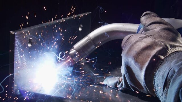 Closeup footage of work metal inert gas welding or metal plate carbon steels welding to structure