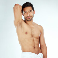 Shower, towel and portrait of fitness man in studio for cleaning, wellness or cosmetics on white...