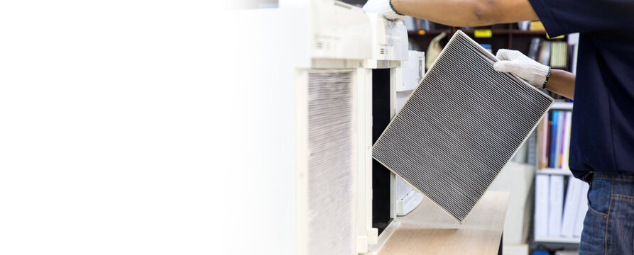 Technician open cover to fix and holding dirty and dust air purifier filter for removing and change. Concept of pm2.5 air pollution clean or heat maintenance air conditioner service repair.