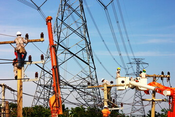 group of electric worker working on pole connected high voltage wires under high volttage pole
