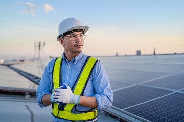 Confident Asian male engineer Get ready to work on inspecting the solar panels. solar power plant...