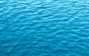 Serene Blue Water Surface with Rippling Waves, Perfect for a Refreshing Swim in Summer