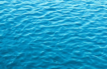 Obraz premium Serene Blue Water Surface with Rippling Waves, Perfect for a Refreshing Swim in Summer