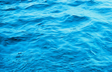 Serene Blue Water Surface with Rippling Waves, Perfect for a Refreshing Swim in Summer