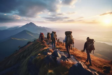 Poster A group of hikers with backpacks walking on a mountain trail at sunrise © Exotic Escape