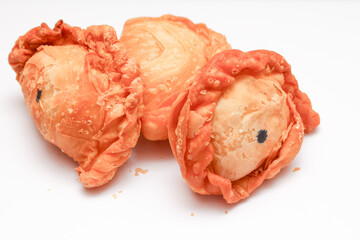 Fried flour snack or curry puff filled with chicken, a popular snack in Thailand. placed on a white background