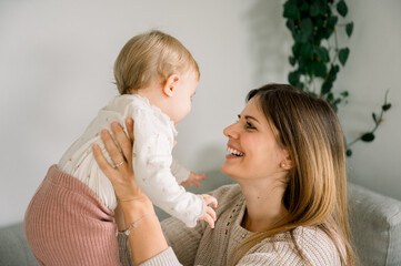 Happy young woman with her baby at home