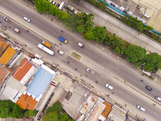 Transportation Photography. Aerial Landscapes. Bird eye view of the long Country Road that connects between cities. City highway in the Bandung area - Indonesia. Aerial Shot from a flying drone.