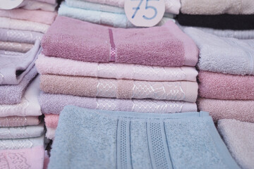 Pile colored of terry towels on the shelf.