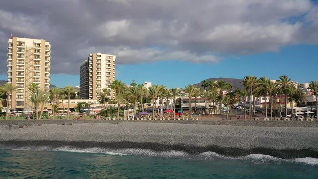 Aerial 4K video from drone to de Tenerife and beachs Adeje Playa de las Americas, Playa Honda,Playa de Troya, Playa de El Bobo.In the background Tenerife at sunset. Tenerife, Canary islands, Spain 