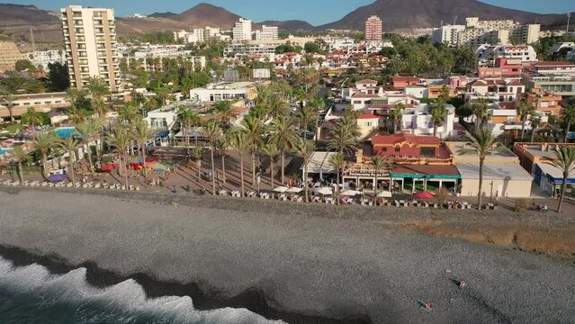 Aerial 4K video from drone to de Tenerife and beachs Adeje Playa de las Americas, Playa Honda,Playa de Troya, Playa de El Bobo.In the background Tenerife at sunset. Tenerife, Canary islands, Spain 