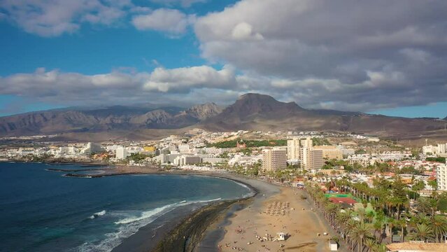 Aerial 4K video from drone to de Tenerife and beachs Adeje Playa de las Americas, Playa Honda,Playa de Troya, Playa de El Bobo.In the background Tenerife at sunset. Tenerife, Canary islands, Spain 