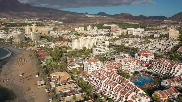 Aerial 4K video from drone to de Tenerife and beachs Adeje Playa de las Americas, Playa Honda,Playa de Troya, Playa de El Bobo.In the background Tenerife at sunset. Tenerife, Canary islands, Spain 