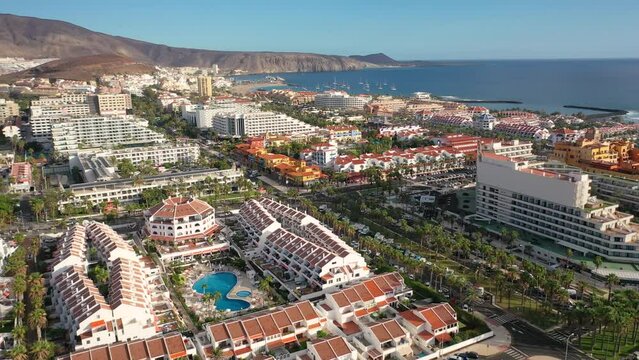Aerial 4K video from drone to de Tenerife and beachs Adeje Playa de las Americas, Playa Honda,Playa de Troya, Playa de El Bobo.In the background Tenerife at sunset. Tenerife, Canary islands, Spain 