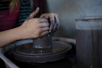 Close up of pottery making process.
