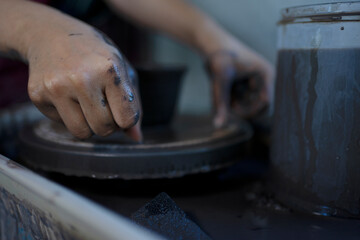 Close up of pottery making process.