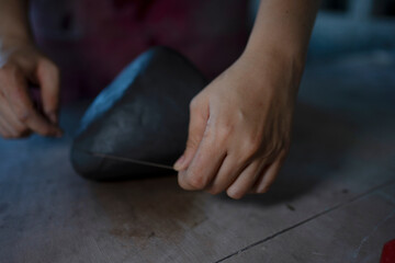 Close up of pottery making process.