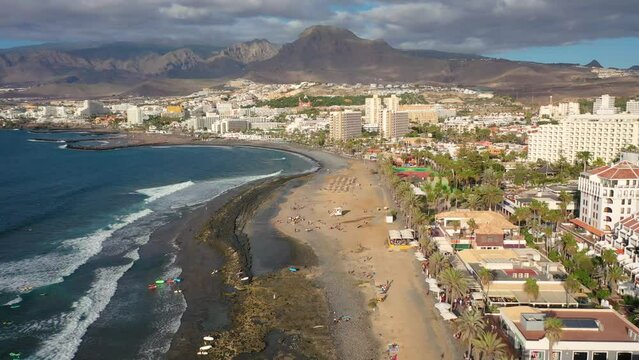Aerial 4K video from drone to de Tenerife and beachs Adeje Playa de las Americas, Playa Honda,Playa de Troya, Playa de El Bobo.In the background Tenerife at sunset. Tenerife, Canary islands, Spain 