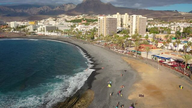 Aerial 4K video from drone to de Tenerife and beachs Adeje Playa de las Americas, Playa Honda,Playa de Troya, Playa de El Bobo.In the background Tenerife at sunset. Tenerife, Canary islands, Spain 