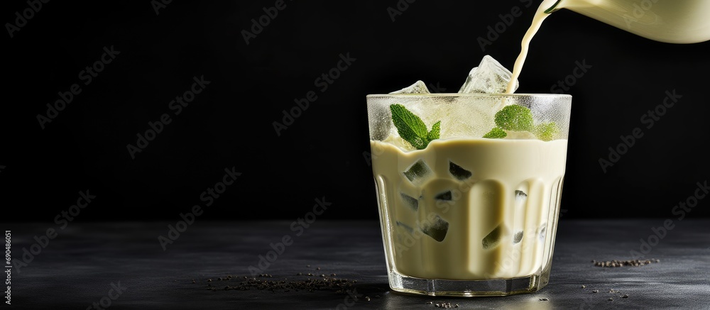 Poster pouring healthy vegan soy milk into matcha ice tea.