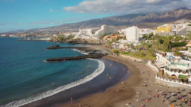 Aerial 4K video from drone to de Tenerife and beachs Adeje Playa de las Americas, Playa Honda,Playa de Troya, Playa de El Bobo.In the background Tenerife at sunset. Tenerife, Canary islands, Spain 