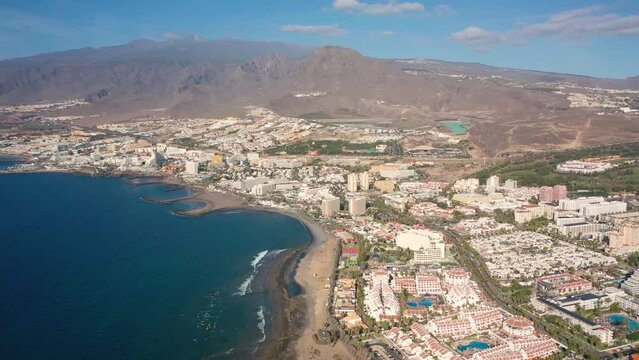 Aerial 4K video from drone to de Tenerife and beachs Adeje Playa de las Americas, Playa Honda,Playa de Troya, Playa de El Bobo.In the background Tenerife at sunset. Tenerife, Canary islands, Spain 