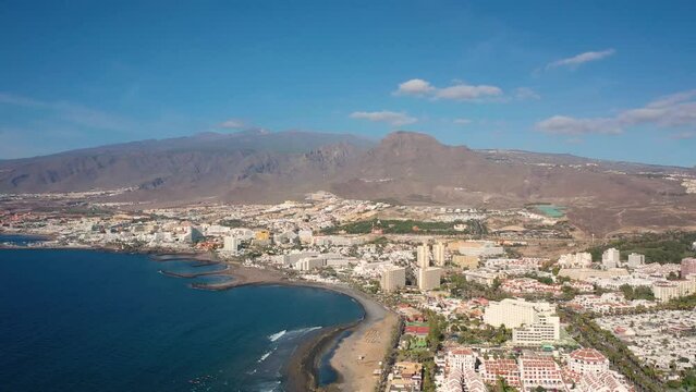 Aerial 4K video from drone to de Tenerife and beachs Adeje Playa de las Americas, Playa Honda,Playa de Troya, Playa de El Bobo.In the background Tenerife at sunset. Tenerife, Canary islands, Spain 