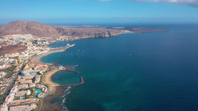 Aerial 4K video from drone to de Tenerife and beachs Adeje Playa de las Americas, Playa Honda,Playa de Troya, Playa de El Bobo.In the background Tenerife at sunset. Tenerife, Canary islands, Spain 