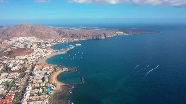 Aerial 4K video from drone to de Tenerife and beachs Adeje Playa de las Americas, Playa Honda,Playa de Troya, Playa de El Bobo.In the background Tenerife at sunset. Tenerife, Canary islands, Spain 