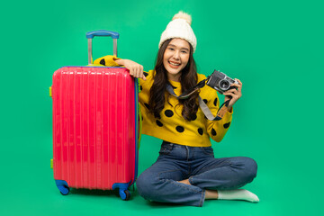 Tourist asian woman in casual clothes hat hold suitcase using mobile cell phone sit isolated on...