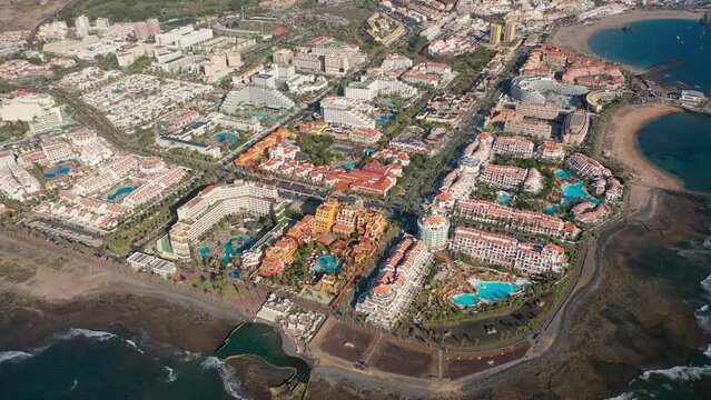 Aerial 4K video from drone to de Tenerife and beachs Adeje Playa de las Americas, Playa Honda,Playa de Troya, Playa de El Bobo.In the background Tenerife at sunset. Tenerife, Canary islands, Spain 