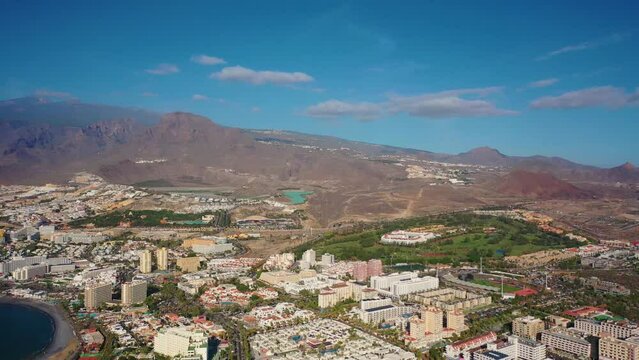 Aerial 4K video from drone to de Tenerife and beachs Adeje Playa de las Americas, Playa Honda,Playa de Troya, Playa de El Bobo.In the background Tenerife at sunset. Tenerife, Canary islands, Spain 