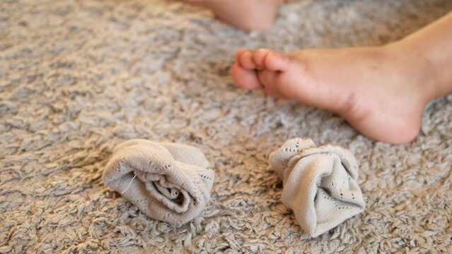 child dirty sock and feet on a carpet 