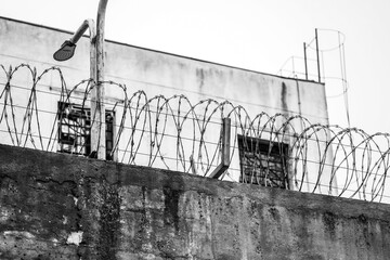 prison. the walls of a prison with barbed wire.