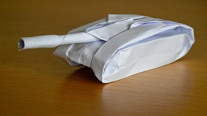 Beautiful isolated close up image of an origami model made with white paper of a single battle tank