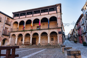 Fototapeta na wymiar Portico with stone arches and columns in the main square of the medieval city of Siguenza.