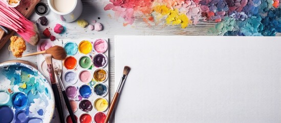 Artist using watercolor paints, seen from above.