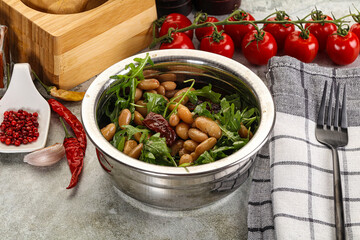 White canned beans with arugula and dry tomatoes