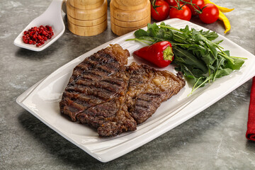 Grilled chuck roll steak with arugula