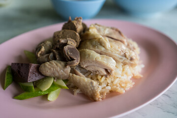 Boiled chicken, offal with cucumber sliced eating with rice and spicy or sweet sauce.