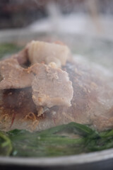 Thai barbecued pork grill on griddle pan. Close up