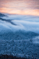 Beautiful winter mountain landscape. Moody sunset seen from the Mount Smerek in the Bieszczady...