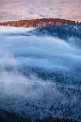 Beautiful winter mountain landscape. Moody sunset seen from the Mount Smerek in the Bieszczady National Park, Poland.