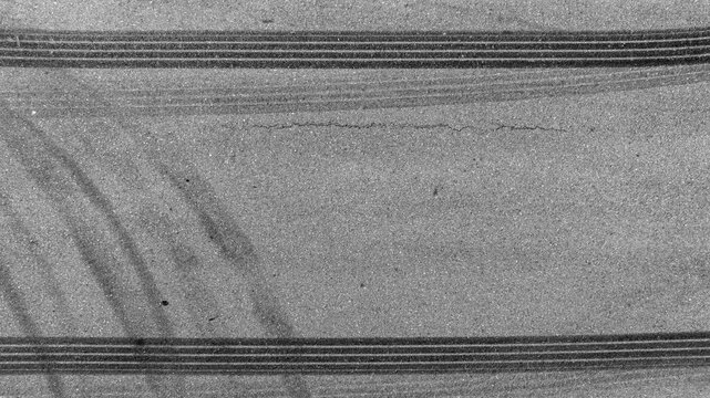 Aerial top view car tire marks burnout, Tire marks on the asphalt road, Tire mark on race track texture and background.