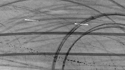 Aerial top view car tire marks burnout, Tire marks on the asphalt road, Tire mark on race track texture and background. © Darunrat