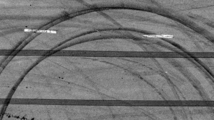 Sierkussen Aerial top view car tire marks burnout, Tire marks on the asphalt road, Tire mark on race track texture and background. © Darunrat