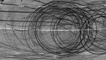 Aerial top view car tire marks burnout, Tire marks on the asphalt road, Tire mark on race track texture and background. © Darunrat