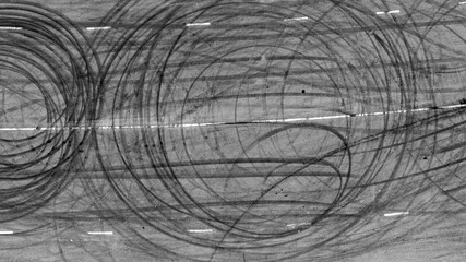 Aerial top view car tire marks burnout, Tire marks on the asphalt road, Tire mark on race track texture and background. © Darunrat