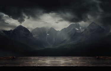  a view of a mountain range in the distance with a dark sky in the foreground and a large body of water in the foreground.