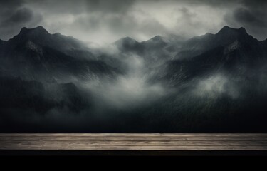  a wooden table with a view of a mountain range in the distance with a dark cloudy sky in the background.